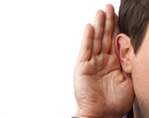 Businessman holds his hand near his ear and listening